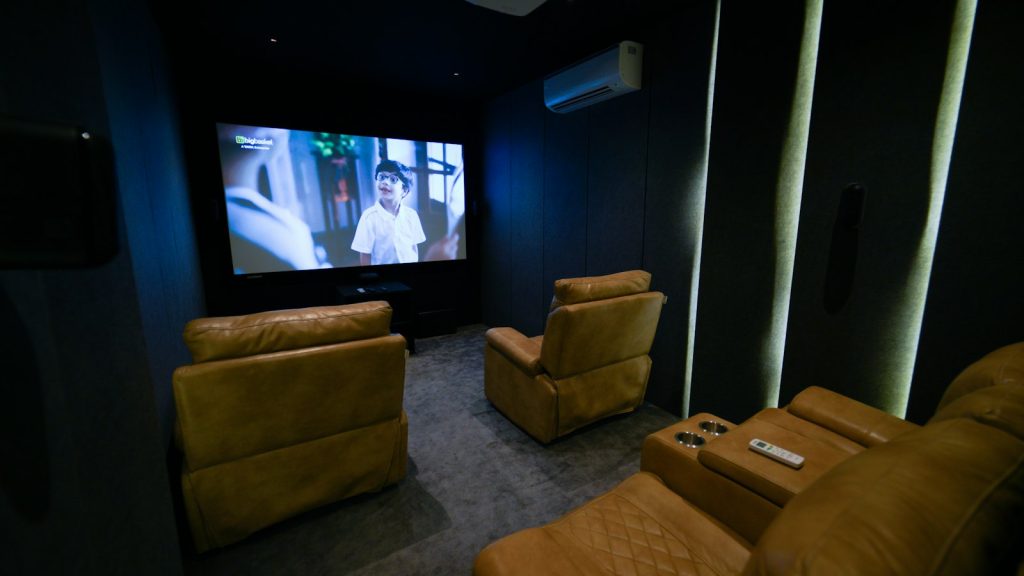 Home theatre room with recliners and a large screen